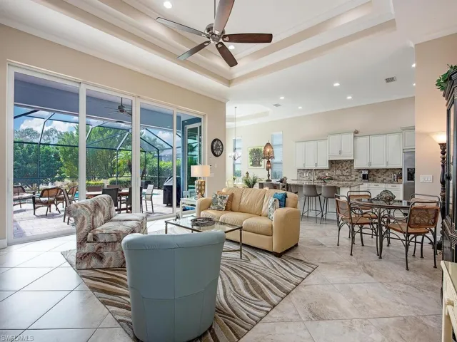 Great room adjacent to the covered lanai, screened lanai and salt water pool.