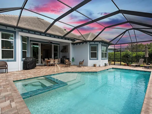 View of pool, spa and the covered lanai with summer kitchen.