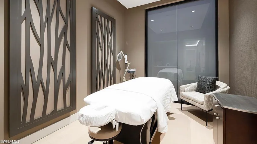 Modern interior space featuring decorative wall panels, light-toned flooring, and integrated ceiling lighting