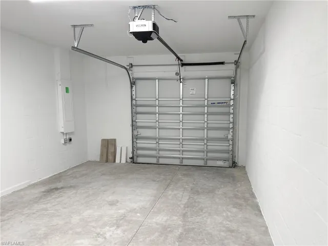 Garage with concrete block wall and a garage door opener