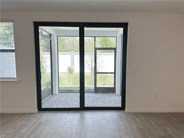 Entryway with plenty of natural light and screened in lanai