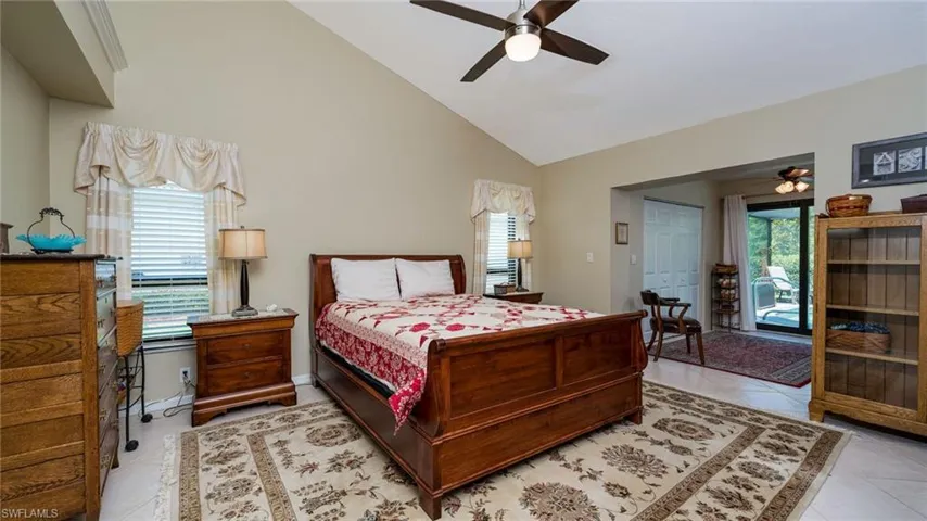 Master Bedroom featuring Walk in Closets, extra bonus pace for office or lounge space & access to lanai/pool area, ceiling fan, tile flooring