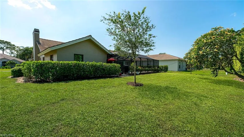 View of yard featuring lush landscaping