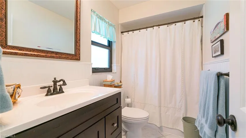 Bathroom with vanity, tub/shower combo, tiled floors