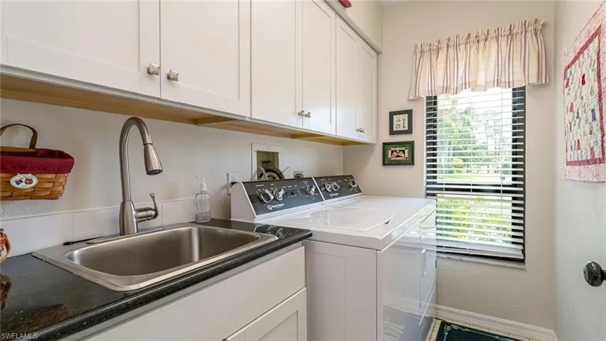 Laundry Room with New Upper Cabinets featuring sink & window