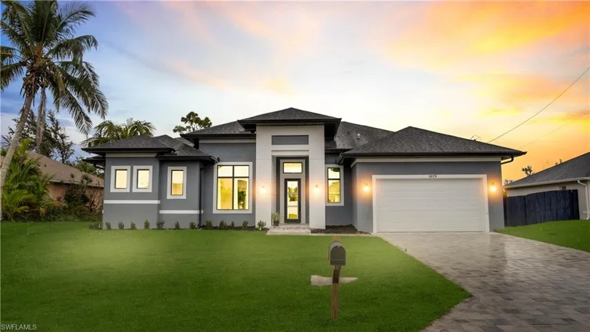 Prairie-style house with an attached garage, stucco siding, decorative driveway, and roof with shingles
