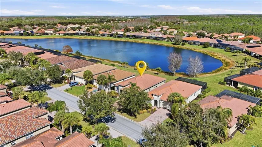 Aerial perspective of suburban area featuring a nearby body of water