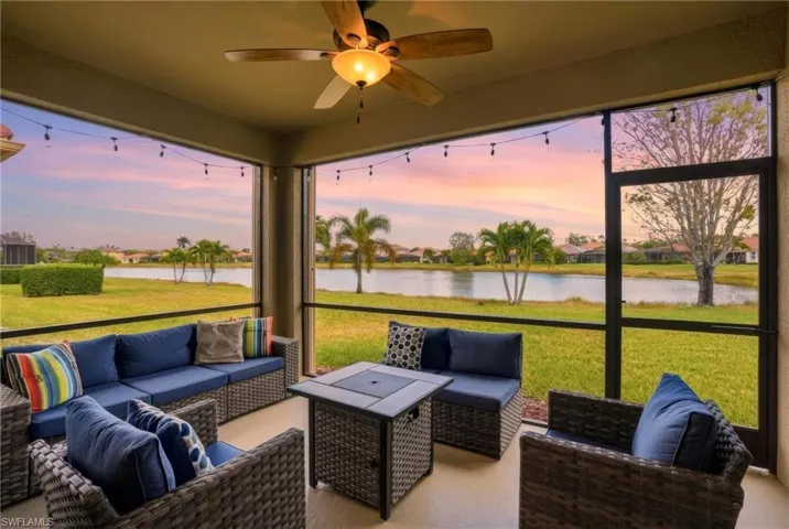 Sunroom with an outdoor living space, a ceiling fan, and a water view
