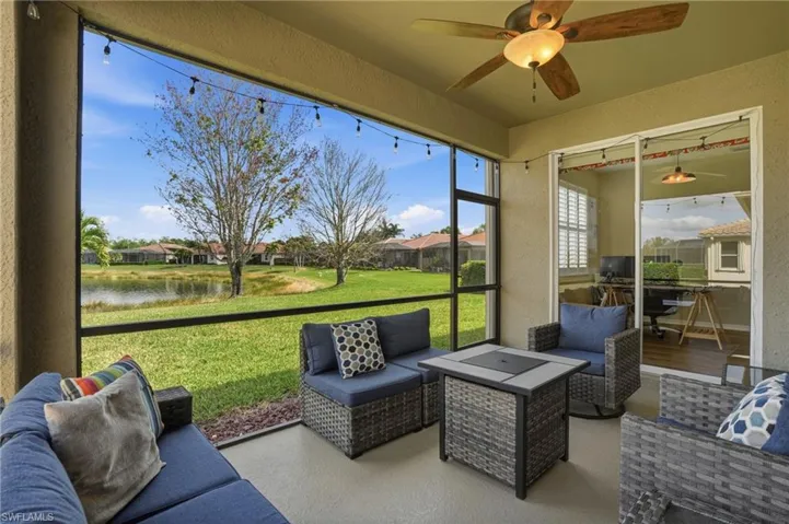 Sunroom with an outdoor hangout area, a ceiling fan, a water view, and a patio