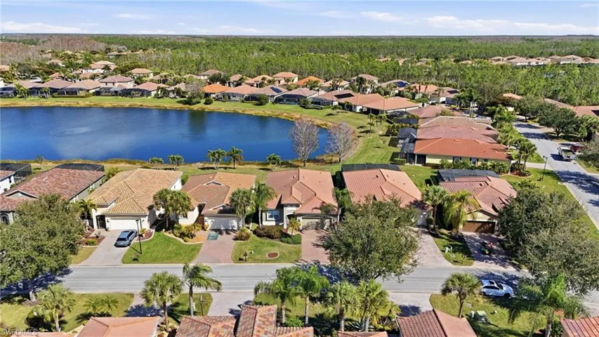 Aerial view of residential area featuring a nearby body of water
