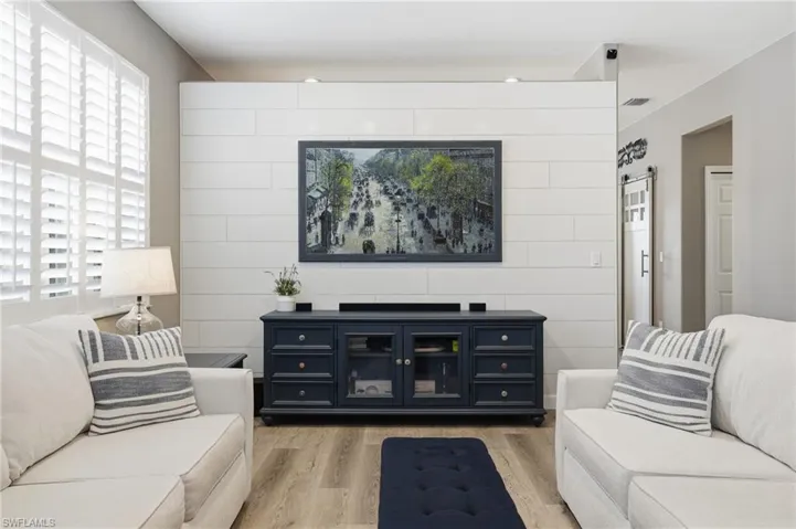 Living area featuring light wood-style floors and a barn door