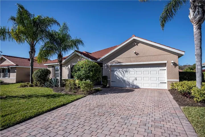 Single story home with a front yard and a garage