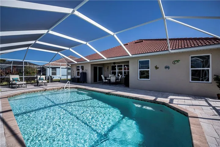 View of pool featuring a lanai, ceiling fan, and a patio