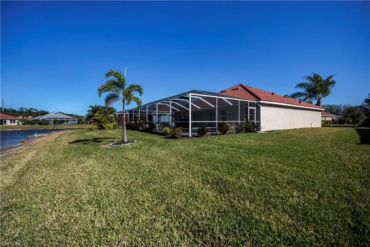 View of yard with a water view and a lanai