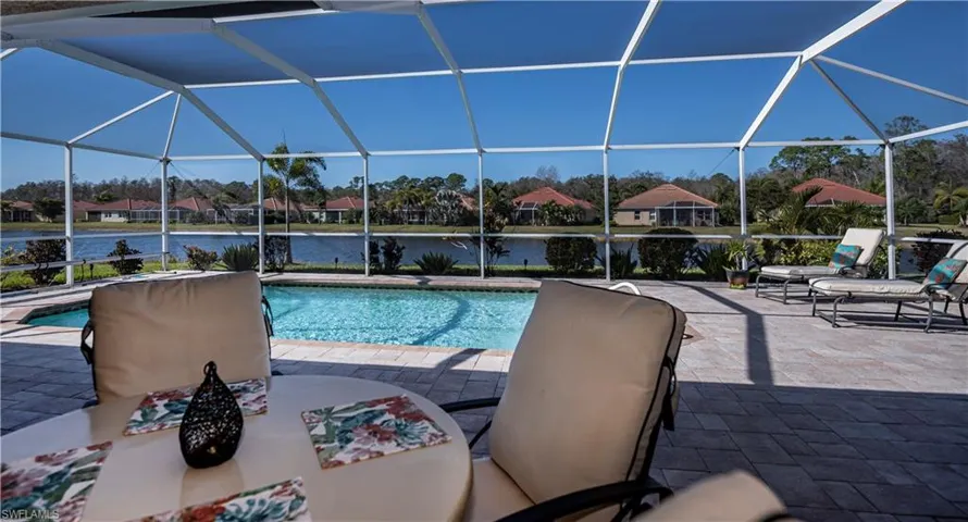 View of pool featuring a water view, a patio area, and a lanai