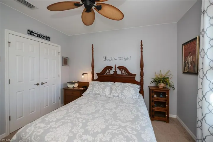 Carpeted bedroom featuring a closet and ceiling fan
