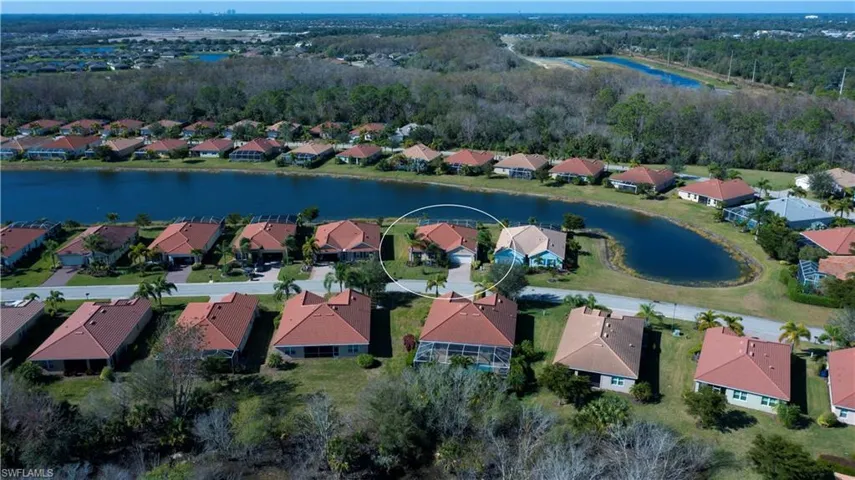 Birds eye view of property with a water view