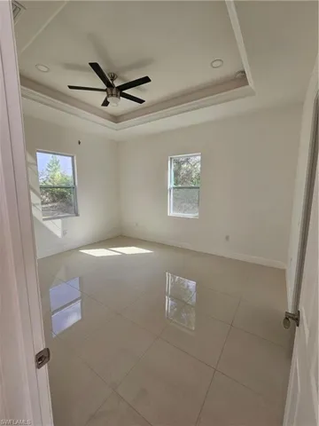 Spare room featuring light tile patterned flooring, ceiling fan, and recessed lighting