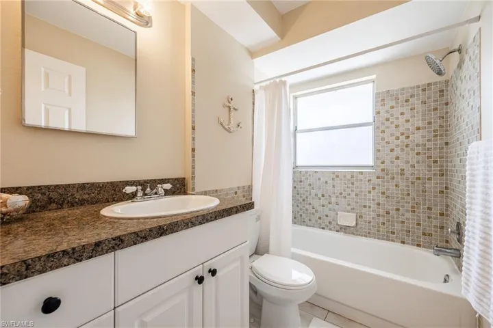 Full bathroom featuring vanity, toilet, tile patterned flooring, and shower / bath combo