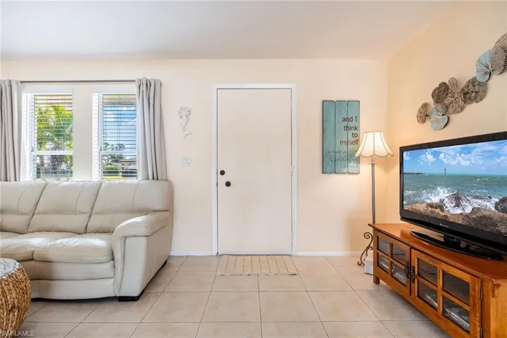 Living room with light tile patterned floors