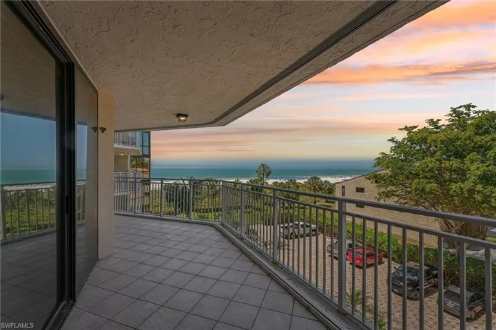 Balcony at dusk featuring a water view