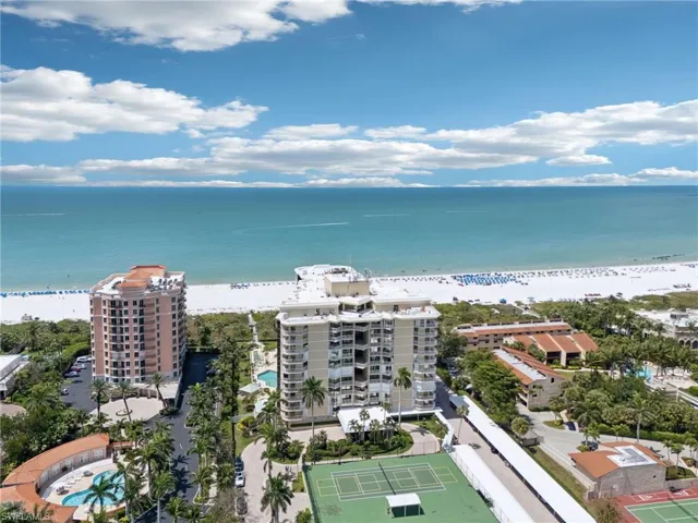 Birds eye view of property featuring a beach view and a water view