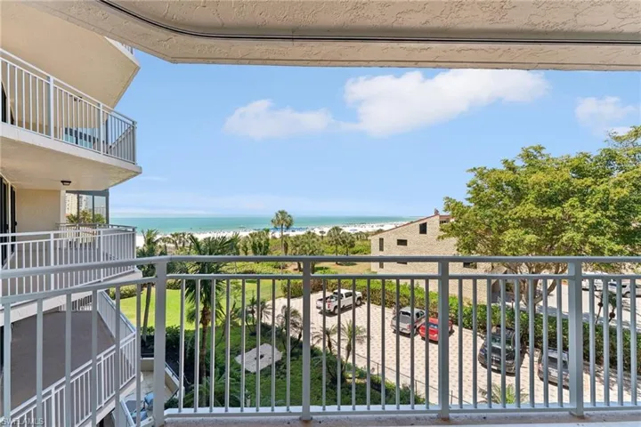 Balcony with a water view and a beach view