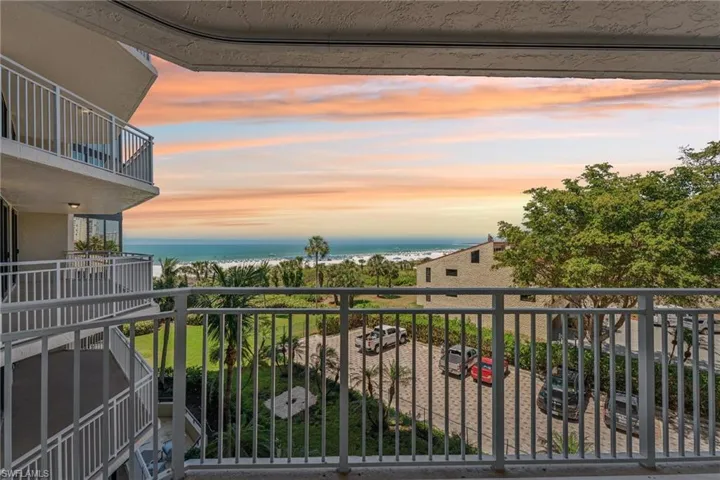 Balcony at dusk featuring a water view