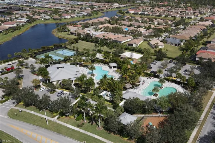 Aerial view of property's location with a large body of water and nearby suburban area