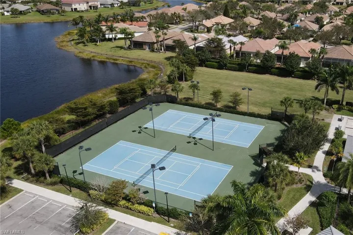 Aerial perspective of suburban area featuring a nearby body of water