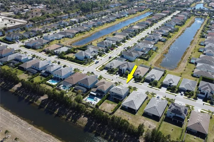 View of property location featuring a large body of water and nearby suburban area