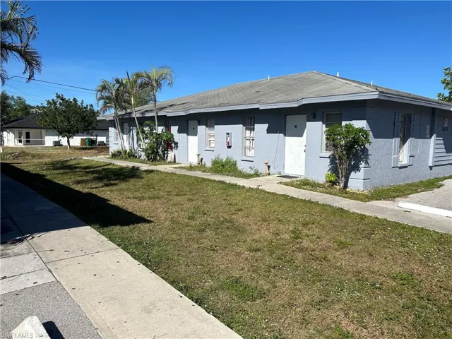 View of side of property featuring a yard