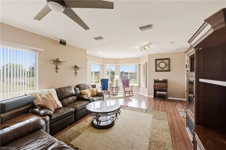 Living area featuring wood finished floors and a ceiling fan