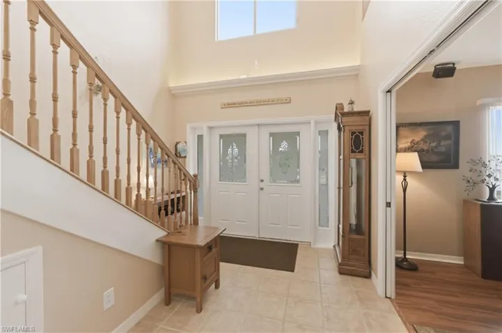 Entryway featuring a high ceiling and stairway