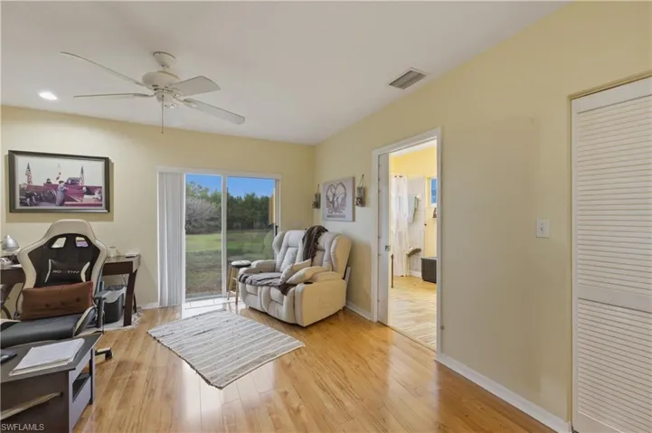 Living room featuring light wood-style floors and ceiling fan