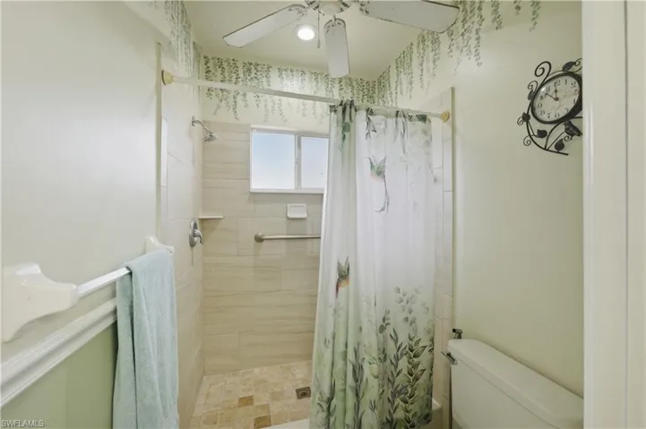 Full bathroom with a stall shower and a ceiling fan