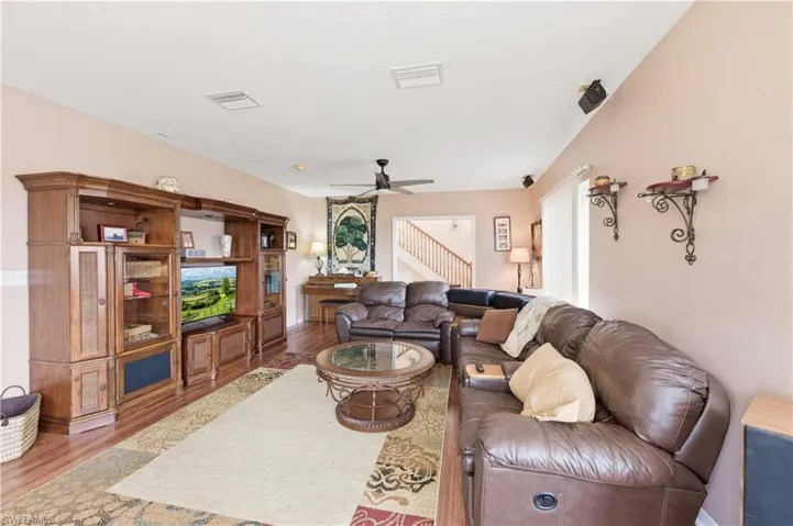 Living room featuring wood finished floors and ceiling fan