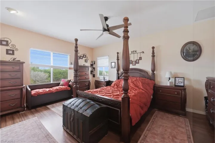 Bedroom featuring dark wood-style flooring and a ceiling fan