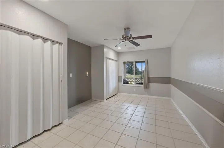 Spare room featuring ceiling fan and light tile patterned flooring