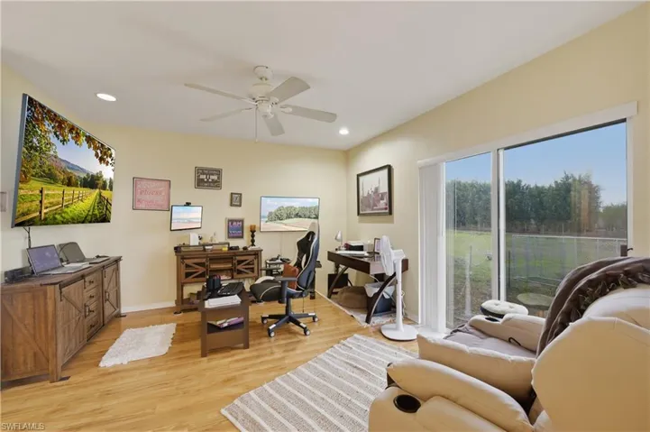 Office area with light wood-style flooring, recessed lighting, and ceiling fan