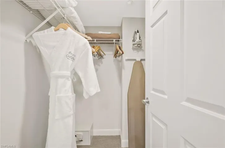 A generously sized walk-in closet offers ample space for storage and organization.