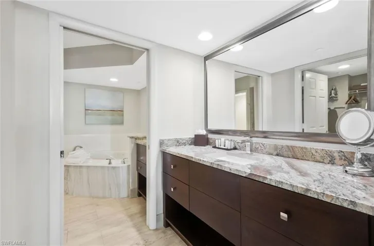 This bathroom showcases a generous vanity and large sink, designed for ease and convenience.