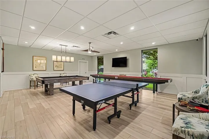 Recessed lighting, wood-finish flooring, and crown molding in clubhouse