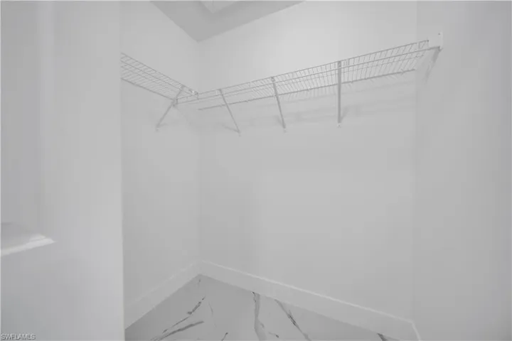 White wall-to-wall wire shelving with corner configuration