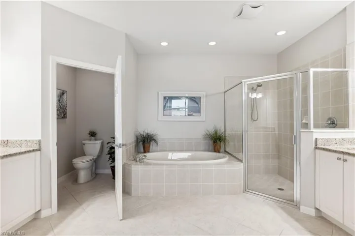Primary Bath Offers a Soaking Tub, Dual Vanities, Walk-In Shower