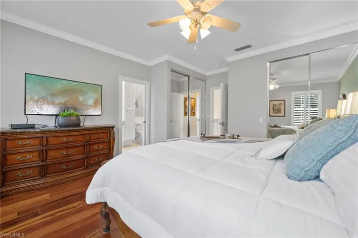 Primary bedroom with view to bathroom and hallway