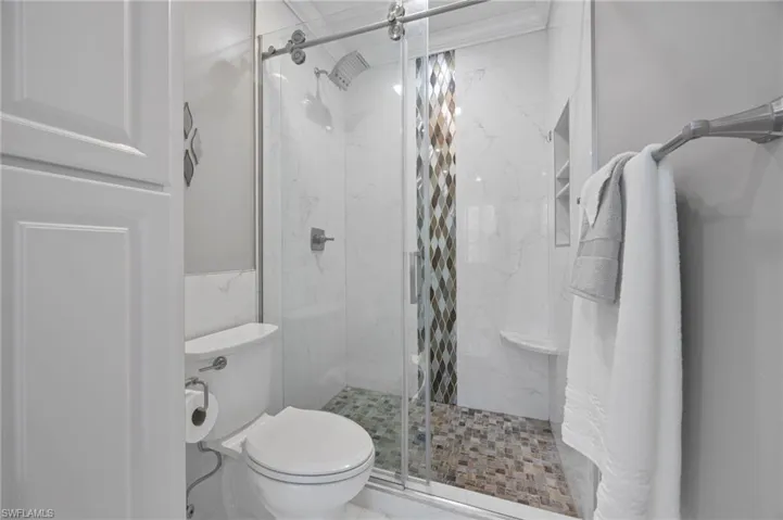 Primary bathroom with new shower enclosure and toilet