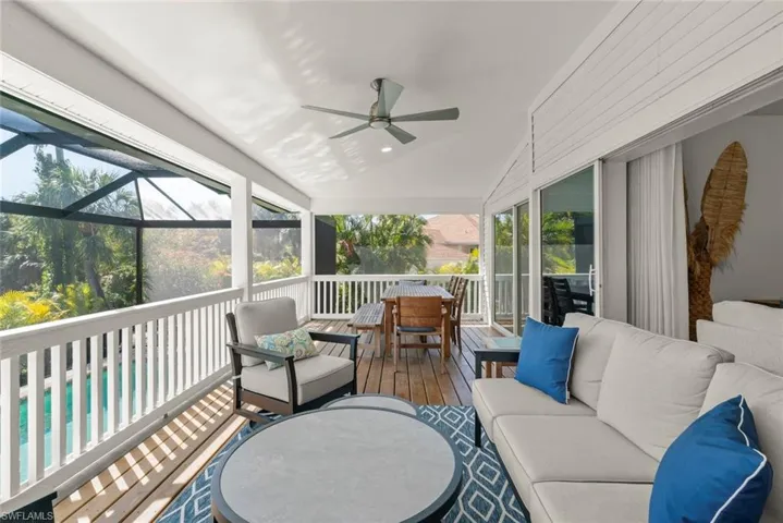 Sunroom with ceiling fan, vaulted ceiling, an outdoor living / dining area, and a deck
