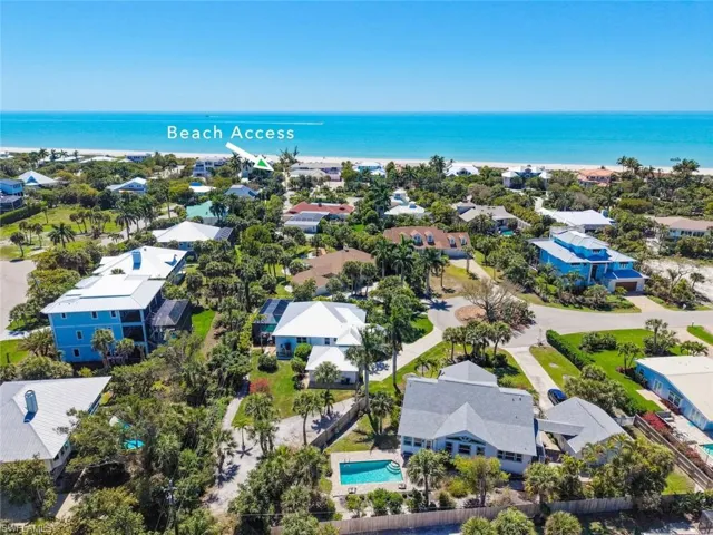 Aerial perspective of suburban area featuring a large body of water