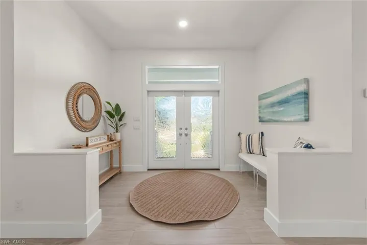 Entryway featuring french doors and wood finished floors